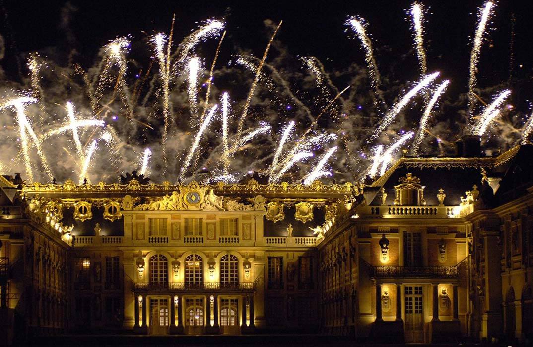 Palace of Versailles in Paris at night with fireworks