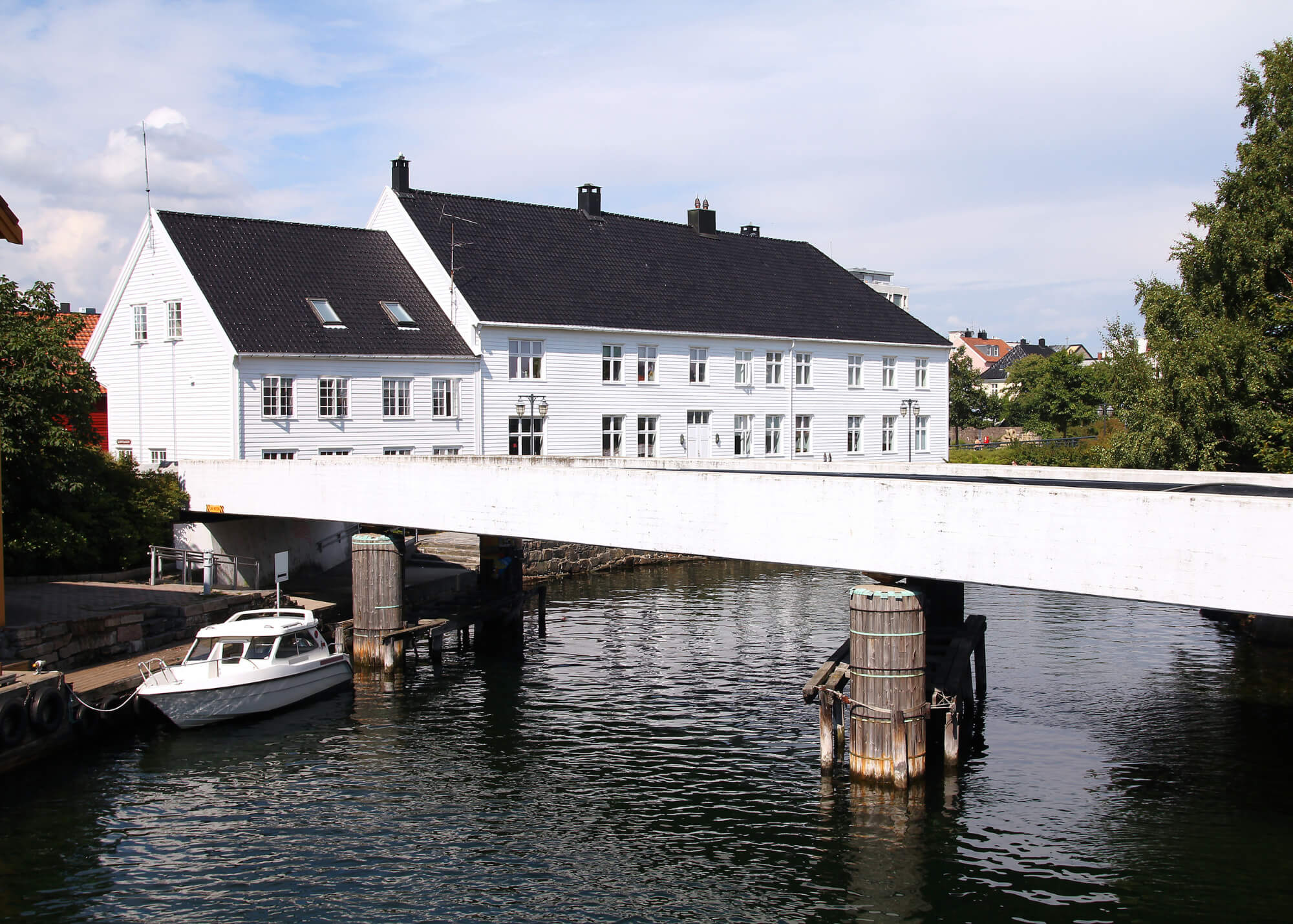 White Kristiansand home with a bridge over water