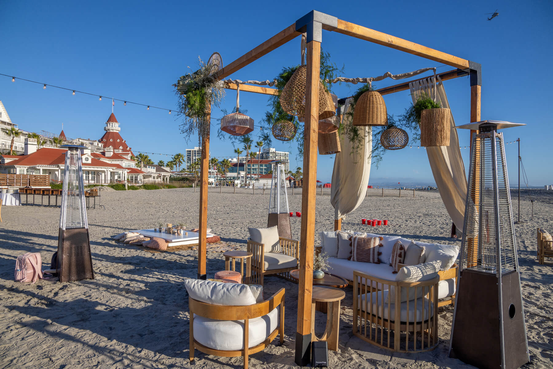 Hosts Global | Mediterranean Decor: Beach decor and event seating setup with hanging basket and boho decor