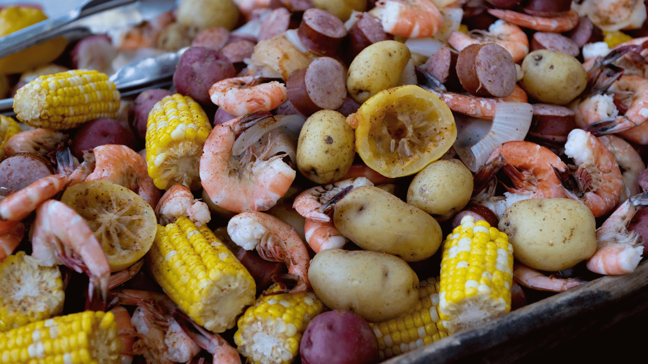 a pile of shrimp and corn on the cob