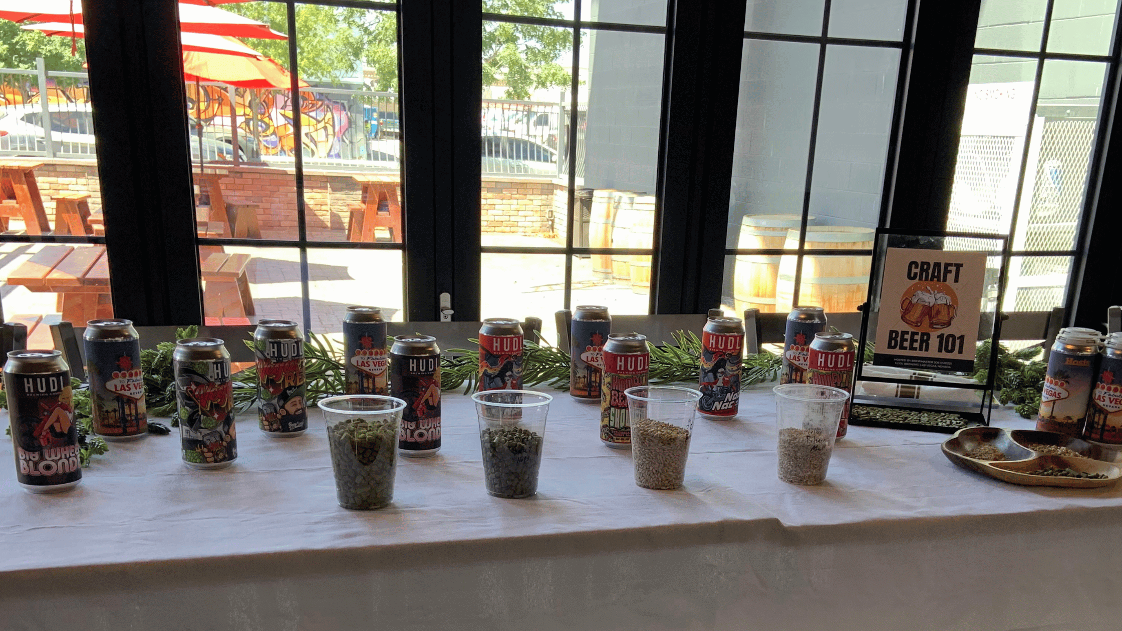 Craft Brew Display on table with hops and barley in cups