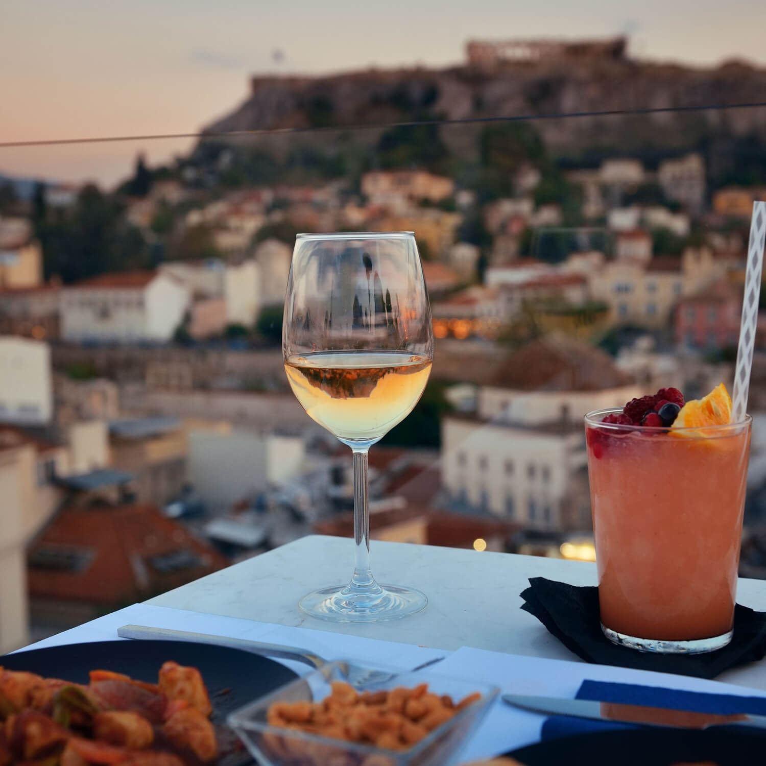 Drinks on a rooftop overlooking the Acropolis in Greece