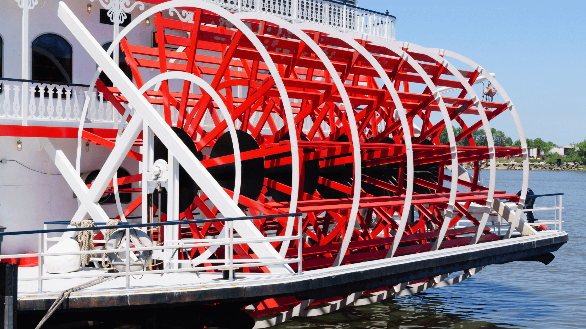 Hosts Global | a red and white paddle wheel on a riverboat