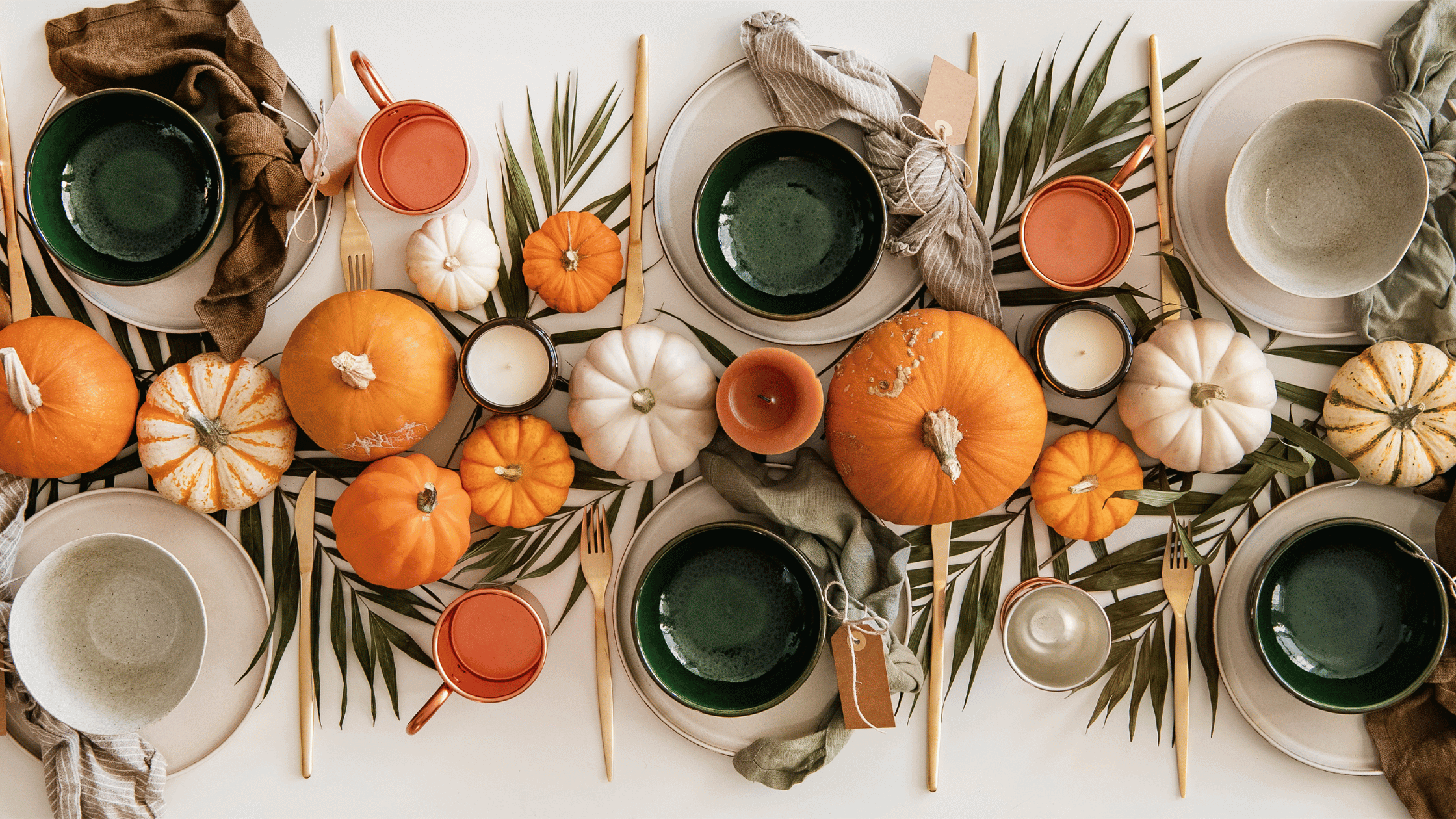 thanksgiving and fall tablescape with pumpkins and candles in fall colors