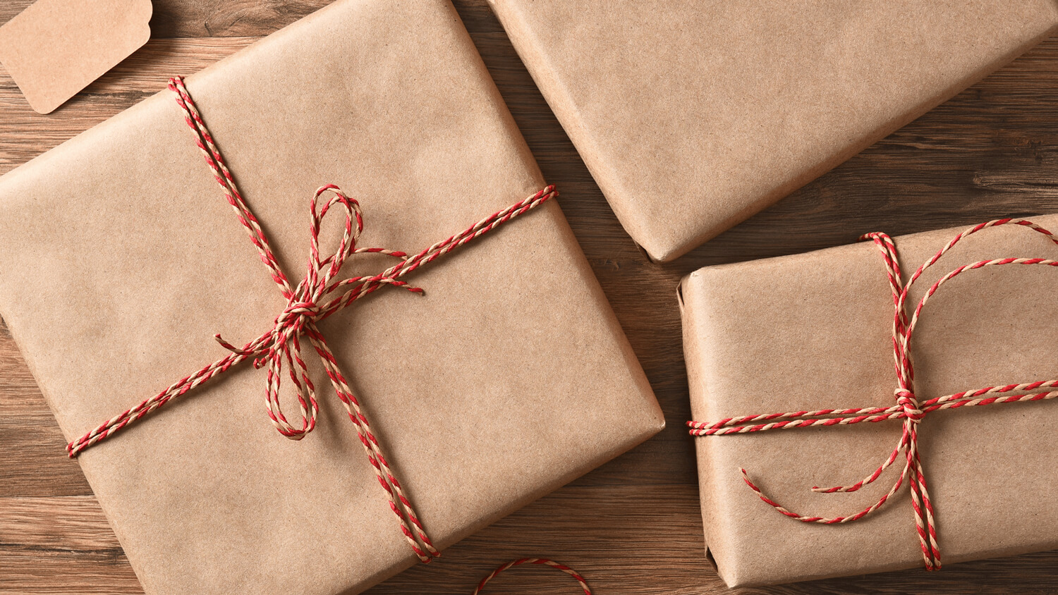 brown paper wrapped presents with red string