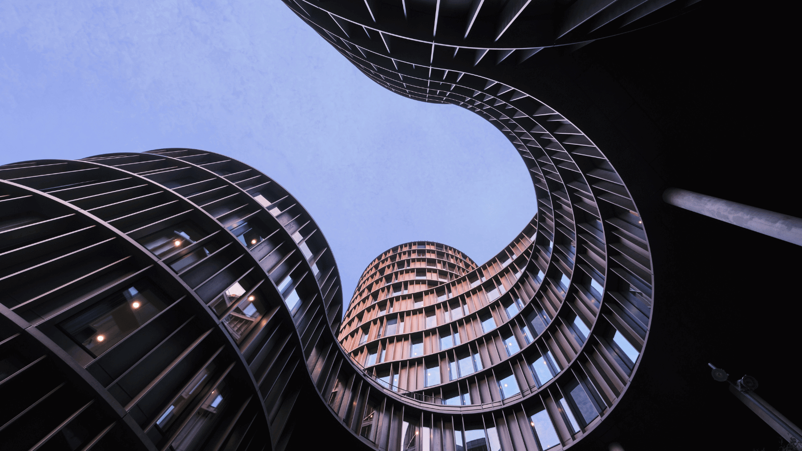 Hosts Global | Spiral winding building in Copenhagen, bottom view looking to the sky